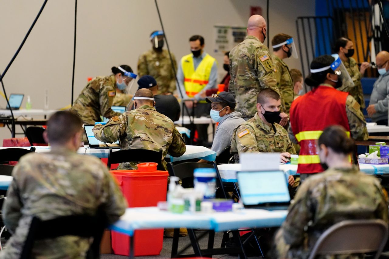 Members of the military inoculate people with the Johnson & Johnson COVID-19 vaccine at the Esperanza Community Vaccination Center in Philadelphia on April 9.