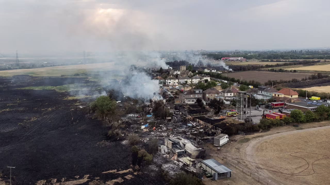 Smoke from fires were being fought by fire services in Wennington, Greater London, England on July 19.