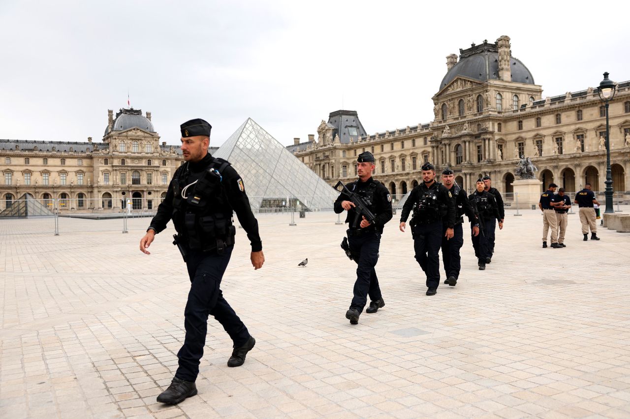 French gendarmes officers are seen in front of the Louvre Museum in Paris, ahead of the opening ceremony of the Olympic Games on July 26. 