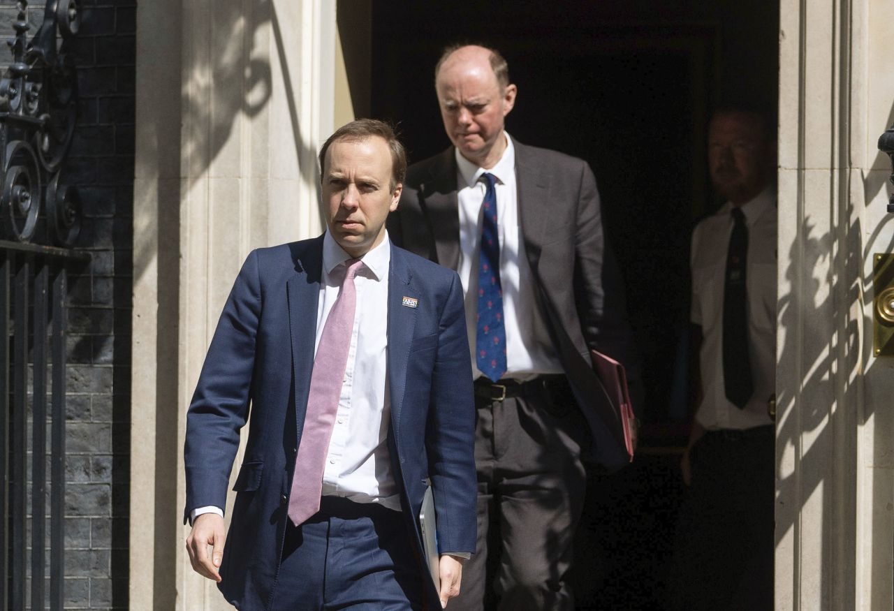 Britain's Health Secretary Matt Hancock, left, and Chief Medical Officer Chris Whitty leave 10 Downing Street, as the United Kingdom enters a seventh week of lockdown to help stop the spread of coronavirus, in London, Monday May 4.