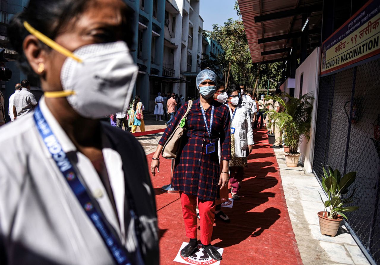 Health workers wait in line to receive the Covid-19 vaccine in Mumbai, India on January 16.