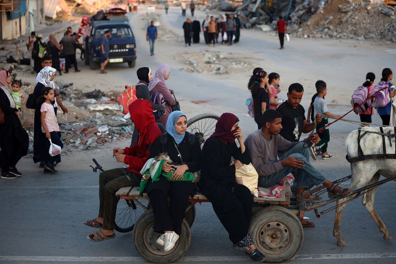 Displaced Palestinians leave the al-Bureij refugee camp and move towards the west, after the Israeli army issued a new evacuation order, in central Gaza on Sunday, July 28.