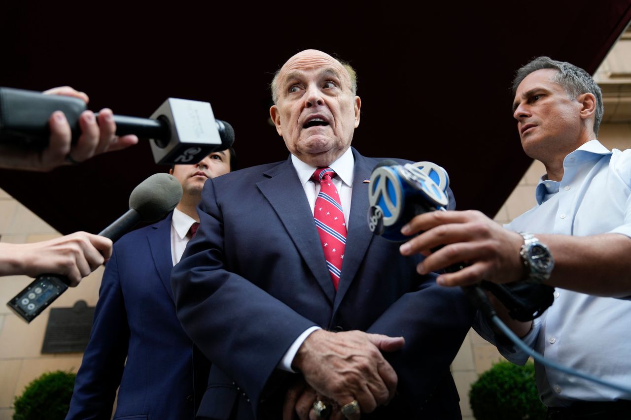 Rudy Giuliani speaks to reporters as he leaves his apartment building in New York on Wednesday.