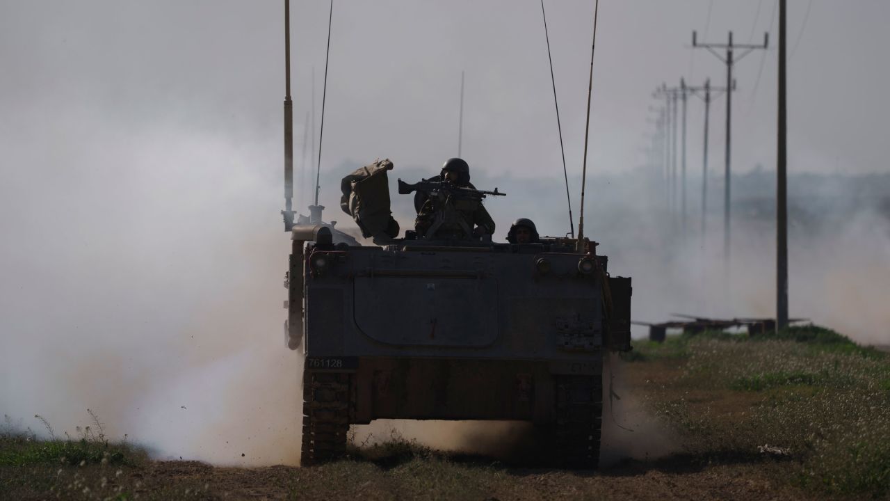 Israeli soldiers travel on an armored personnel carrier near the Israeli-Gaza border on Sunday.