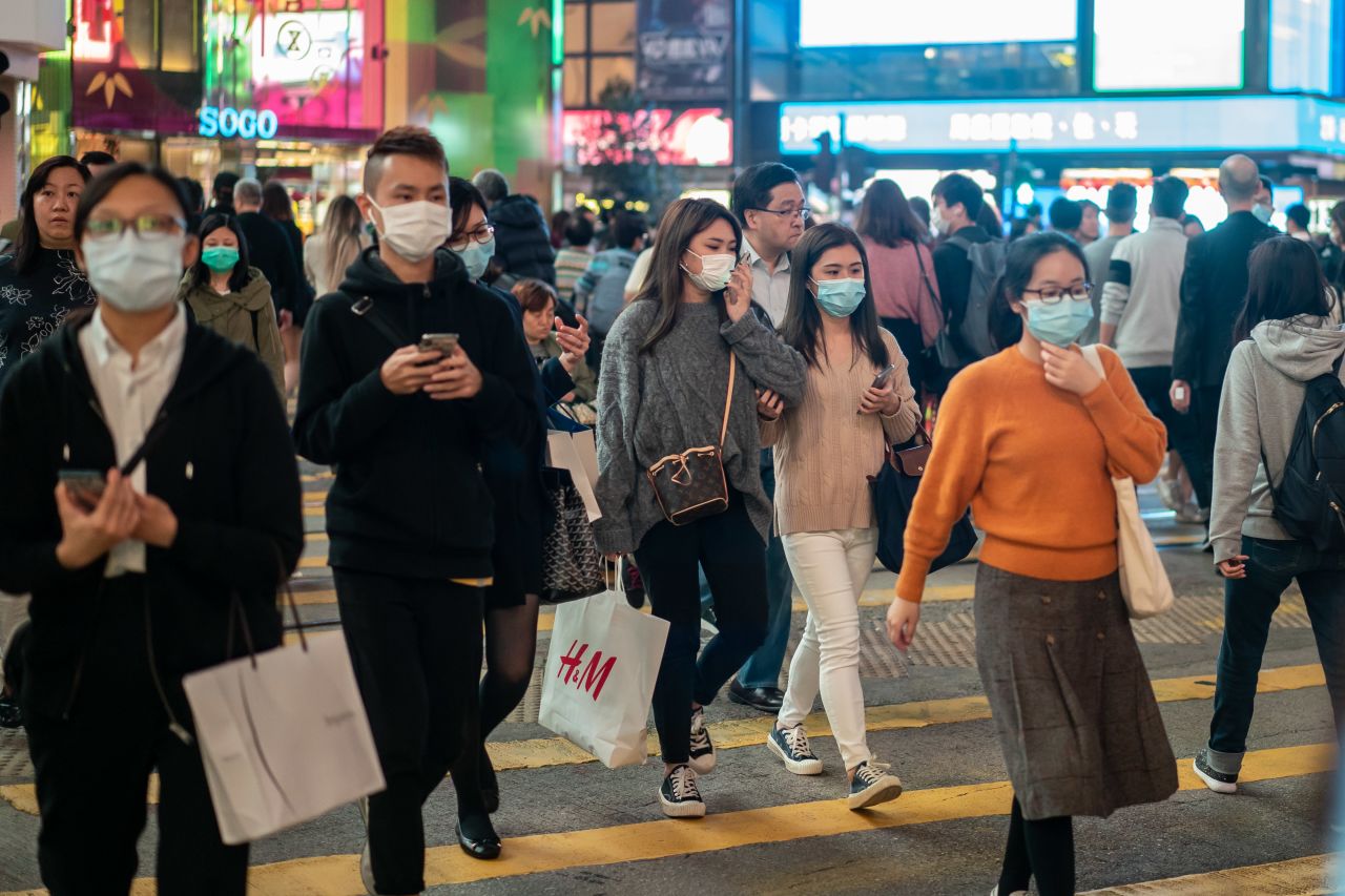 Pedestrians wear face masks as they walk through a crosswalk in Causeway Bay on January 23, 2020 in Hong Kong.