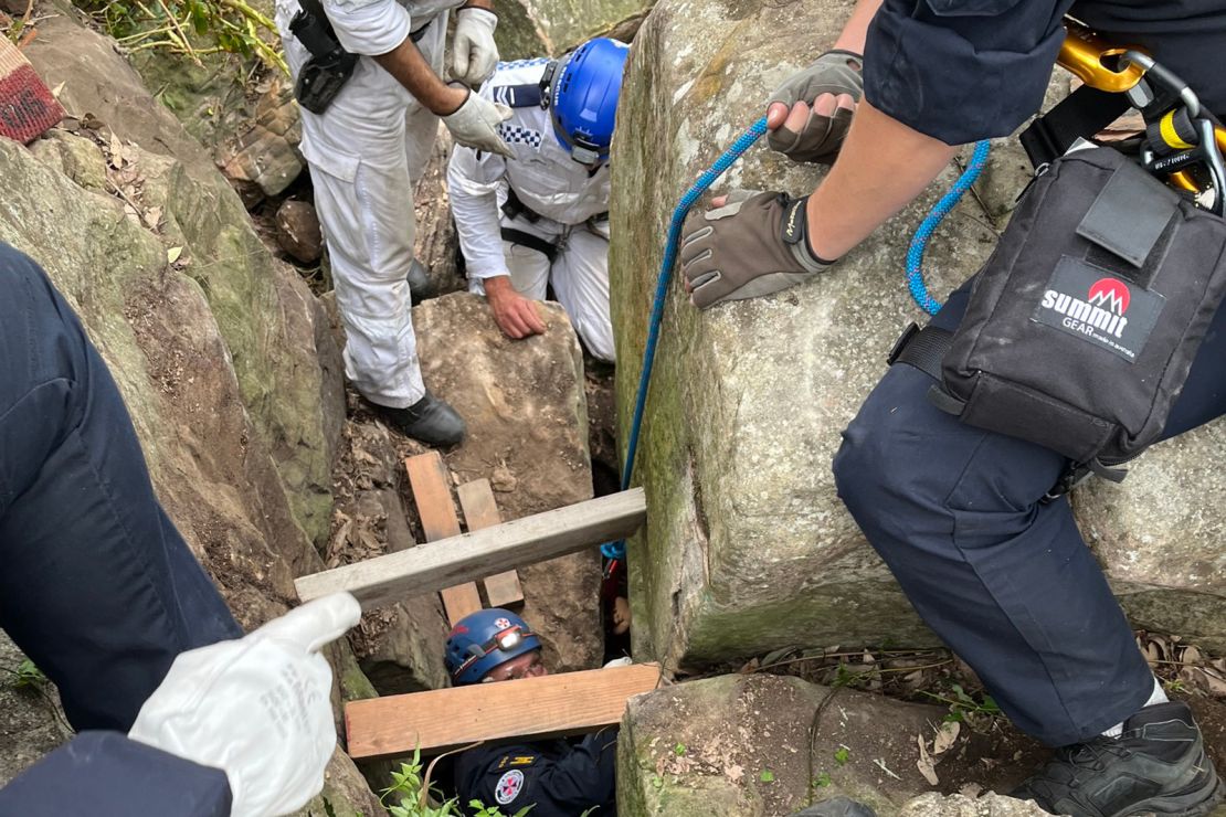 Rescuers had to remove several large boulders to get to her feet and pull her out.