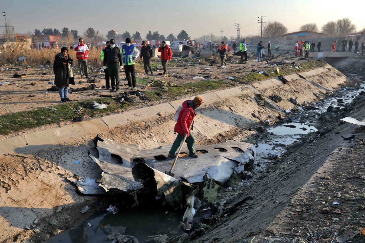 Emergency crews inspect the scene of the plane crash.