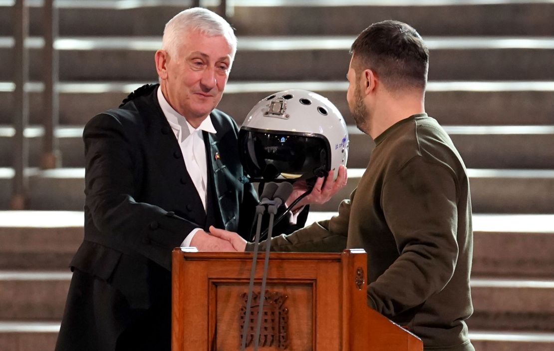 Speaker of the House of Commons, Sir Lindsay Hoyle, left, holds the helmet of one of the most successful Ukrainian pilots, inscribed with the words "We have freedom, give us wings to protect it", which was presented to him by Ukrainian President Volodymyr Zelensky inside the Palace of Westminster on February 8. 