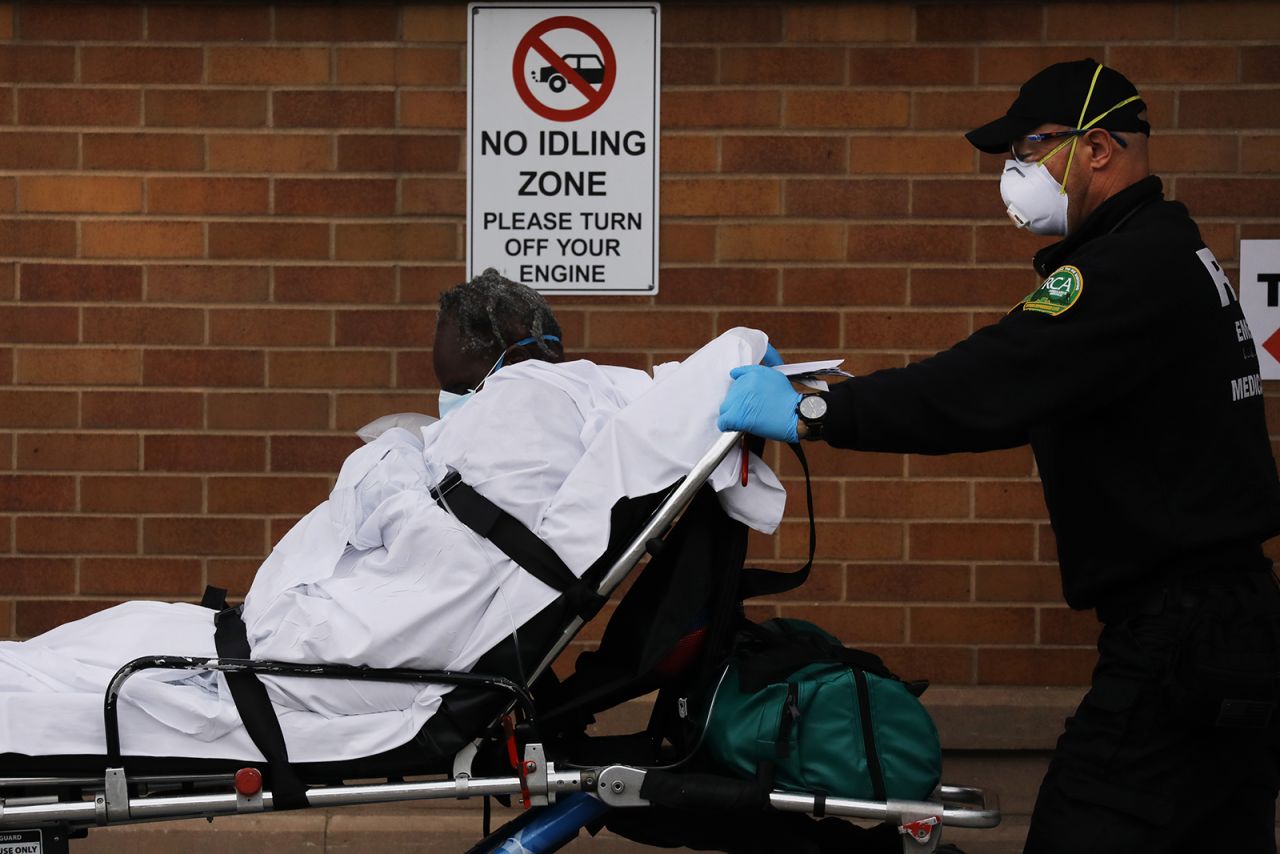 Medical workers transport a patient outside of a special coronavirus intake area at Maimonides Medical Center on April 27, in the Brooklyn borough of New York City. 