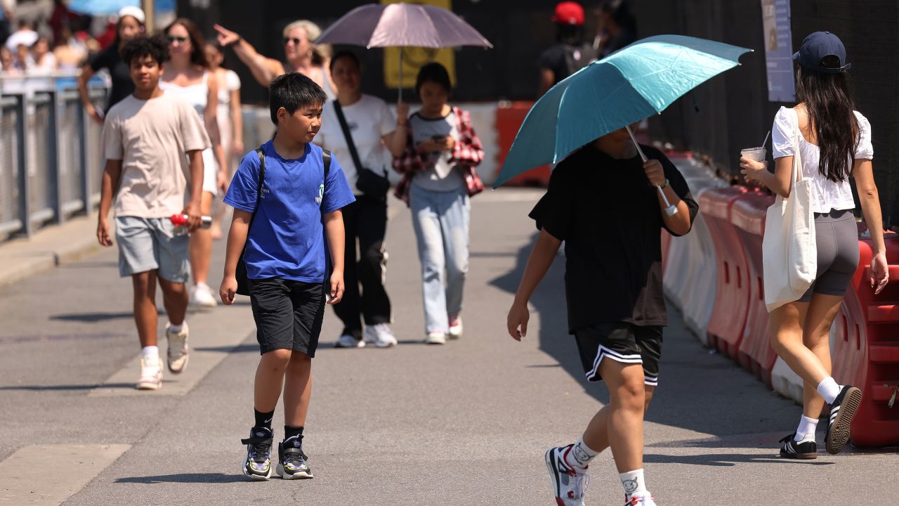 People walk along Brooklyn Bridge Park on June 19 in New York City. 