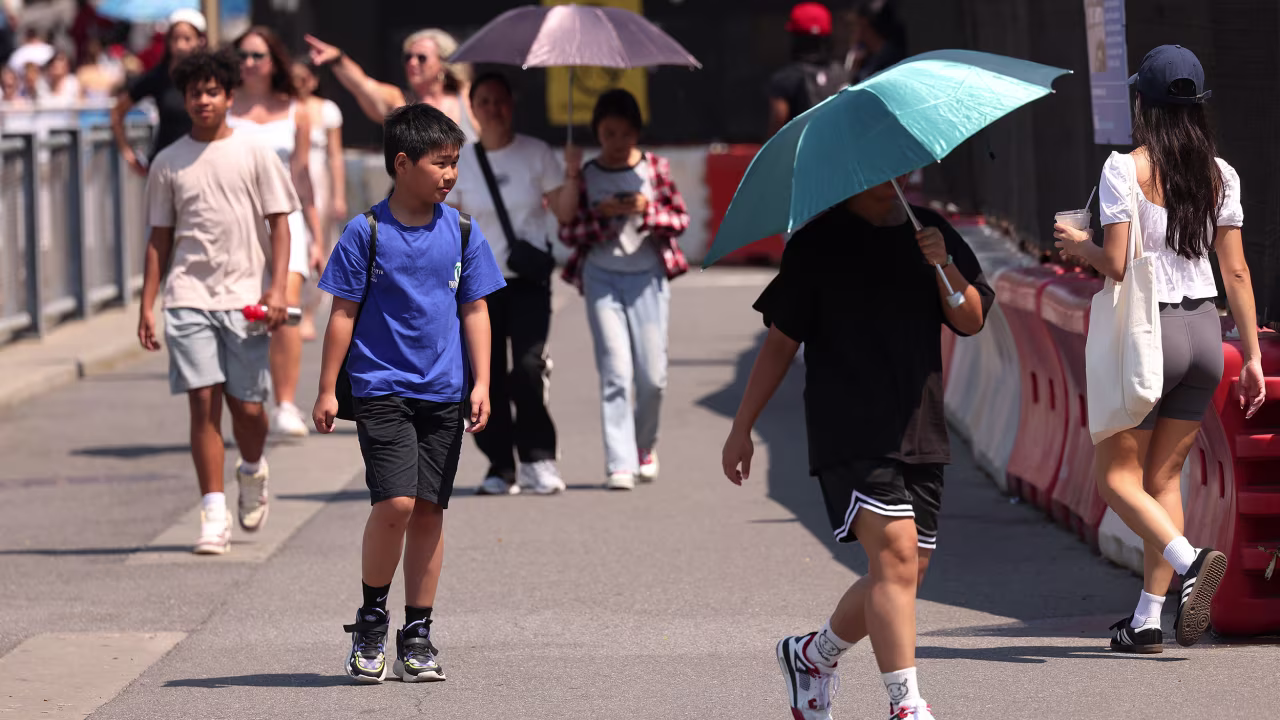 People walk along Brooklyn Bridge Park on June 19 in New York City. 