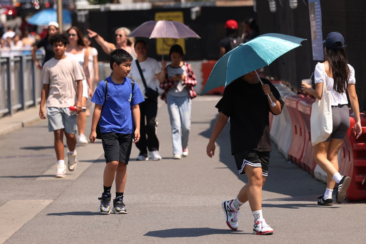 People walk along Brooklyn Bridge Park on June 19 in New York City. 