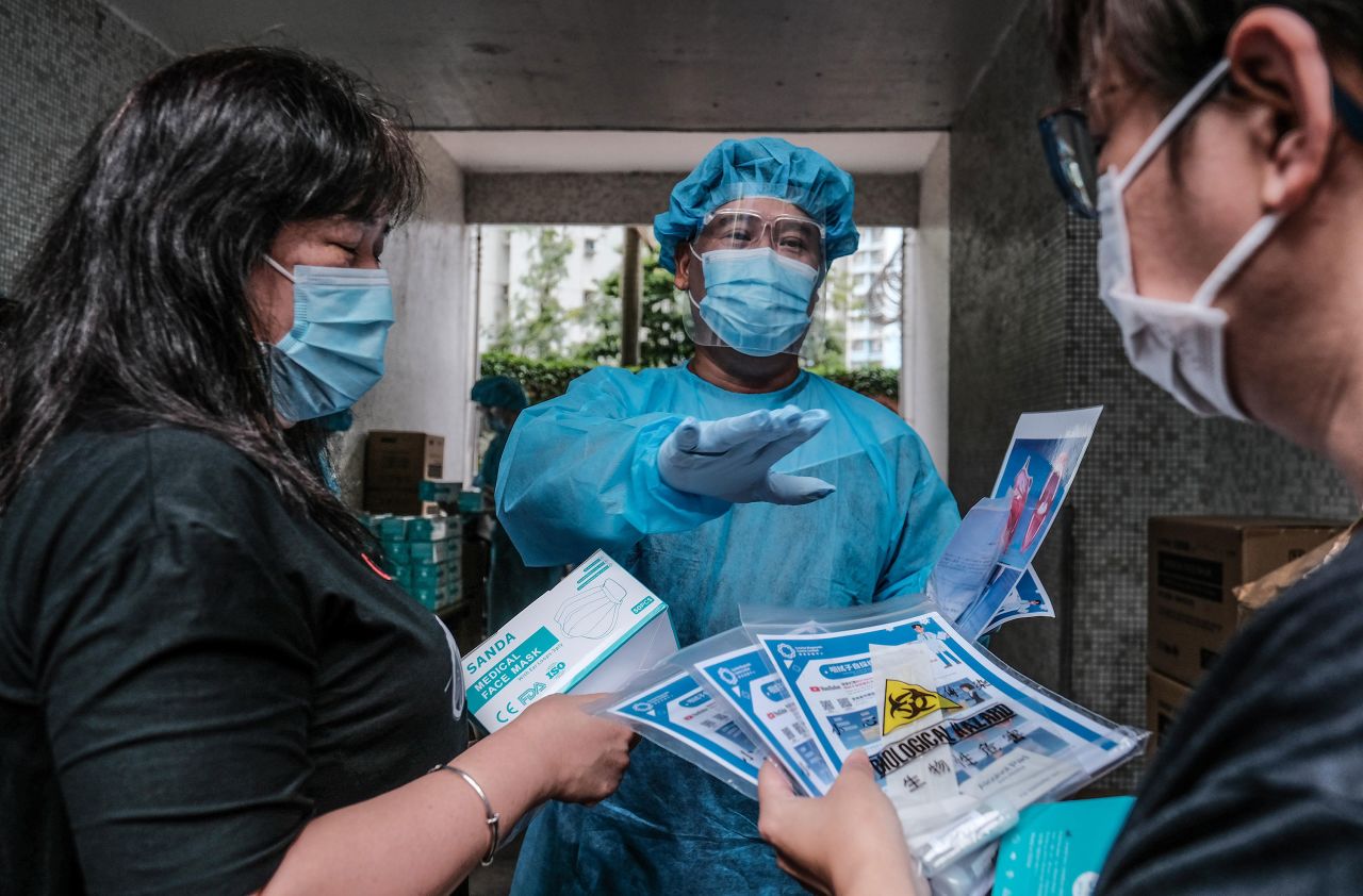 Medical workers hand out coronavirus test kits to local residents on August 7 in Hong Kong. 