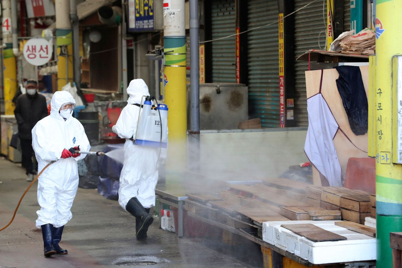 Workers spray disinfectant at a market in Busan, South Korea on Sunday.