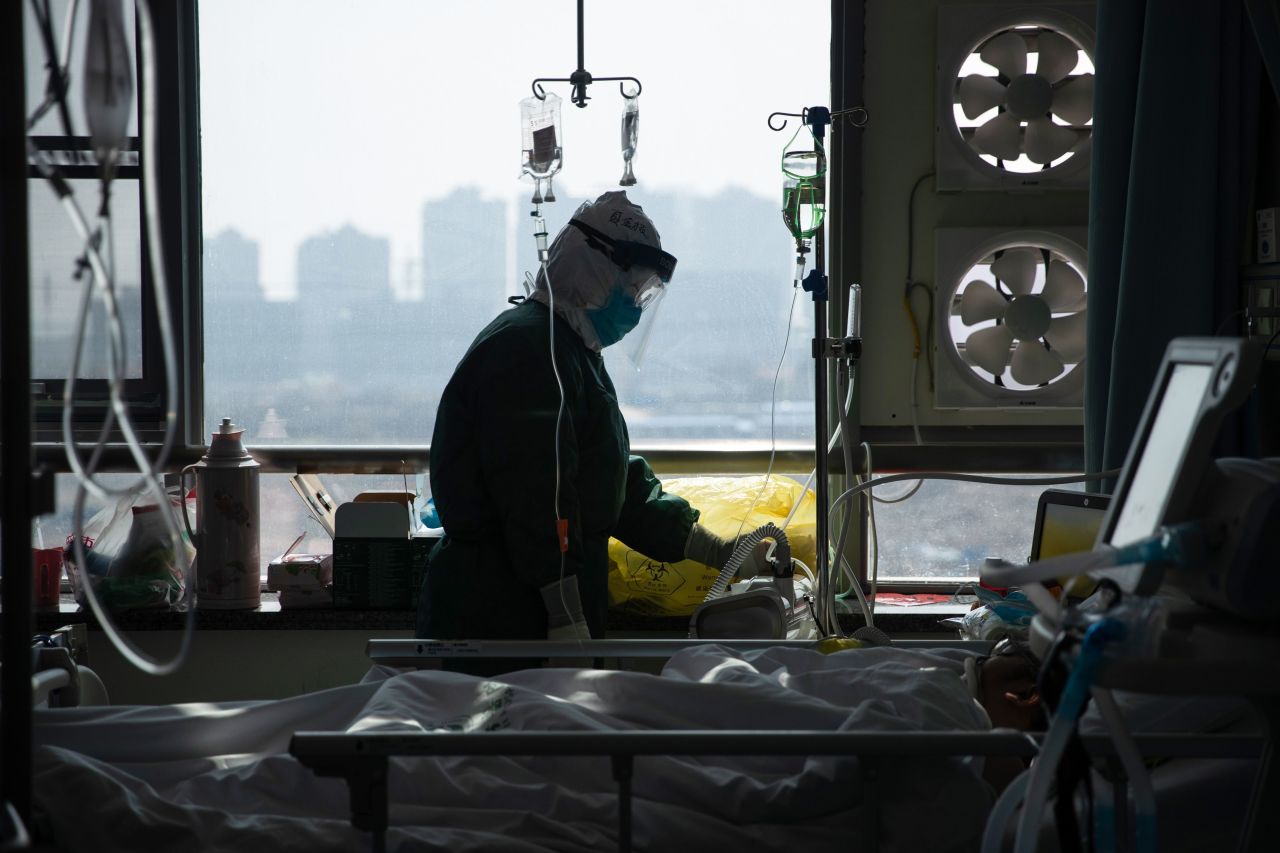 A medical staff member treats a patient infected by the coronavirus at a hospital in Wuhan in China's central Hubei province.