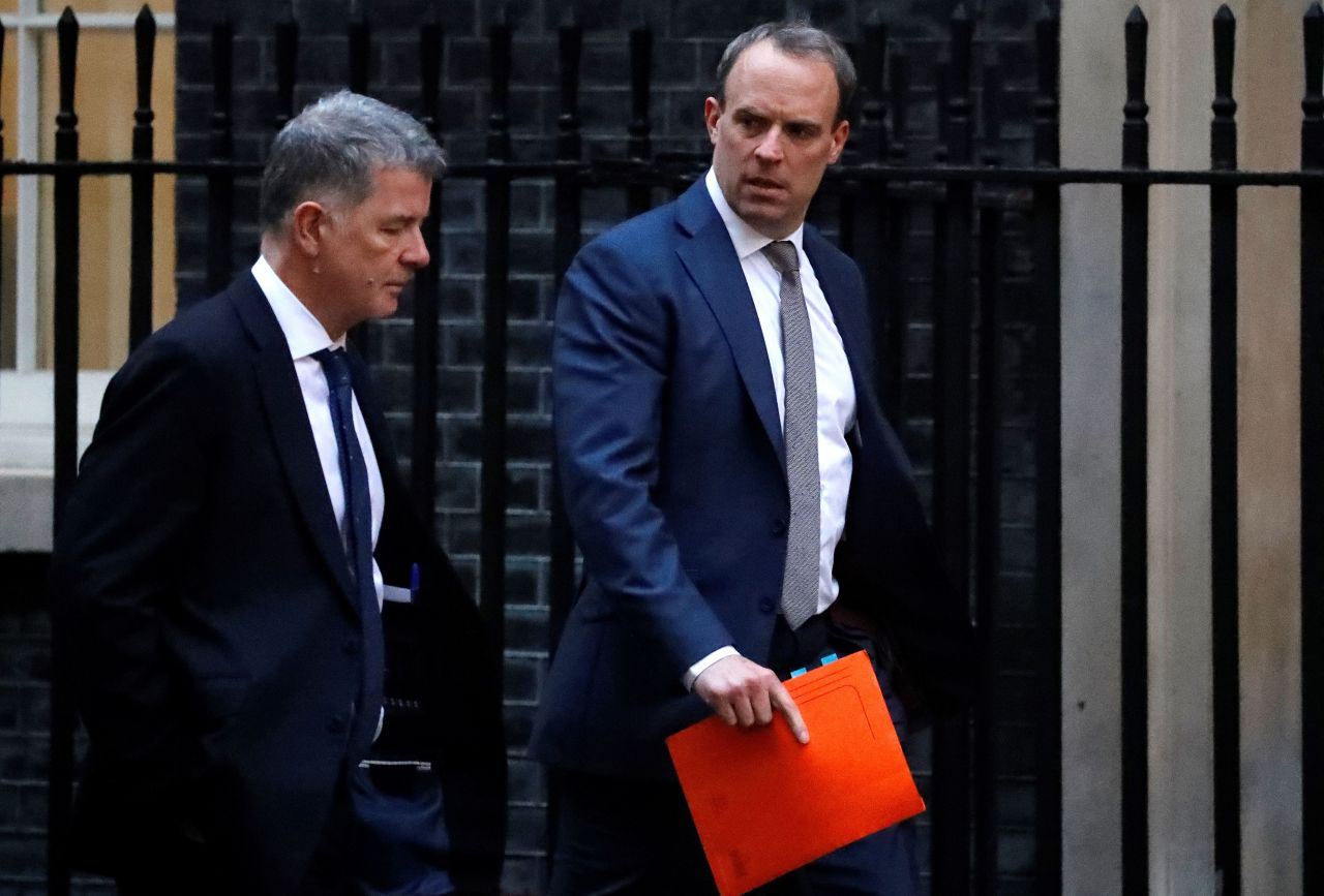 UK Foreign Secretary Dominic Raab (R) walks towards 10 Downing Street on January 6, 2020.