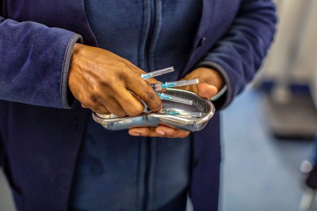 A health worker prepares doses of the Johnson & Johnson Covid-19 vaccine onboard a pop-up vaccination bus in Cape Town, South Africa, on August 26.