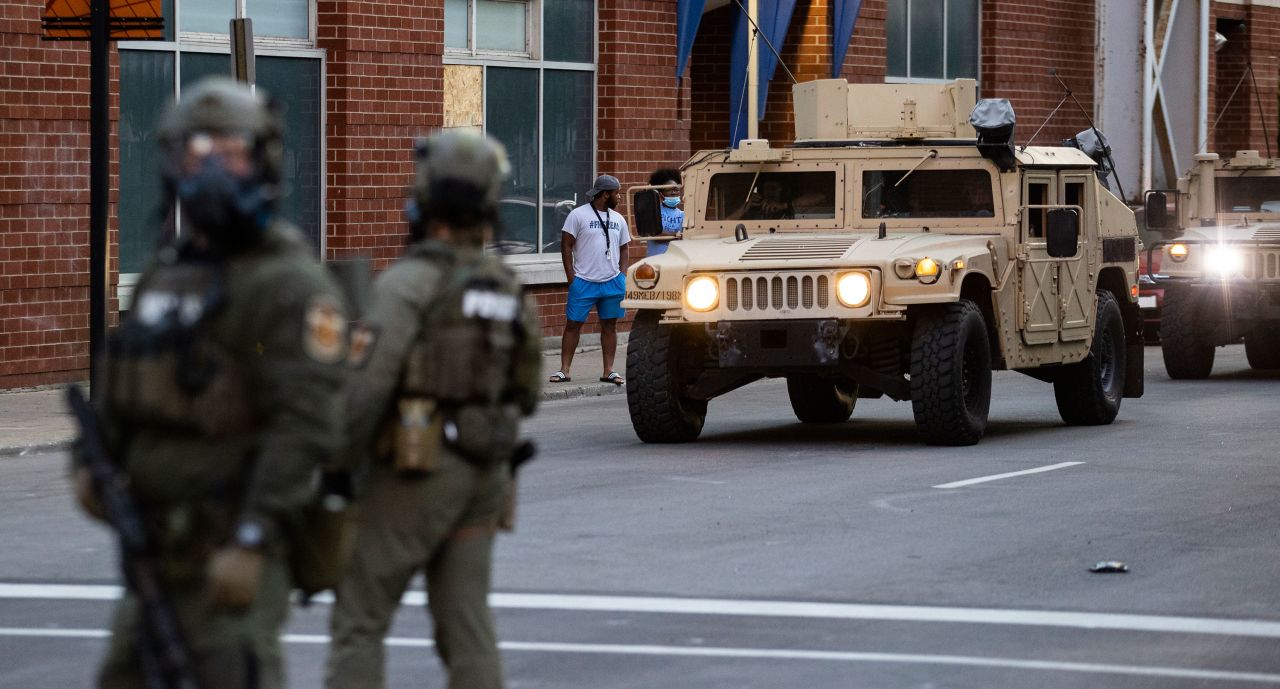 National Guard vehicles drive into downtown Louisville on May 30.