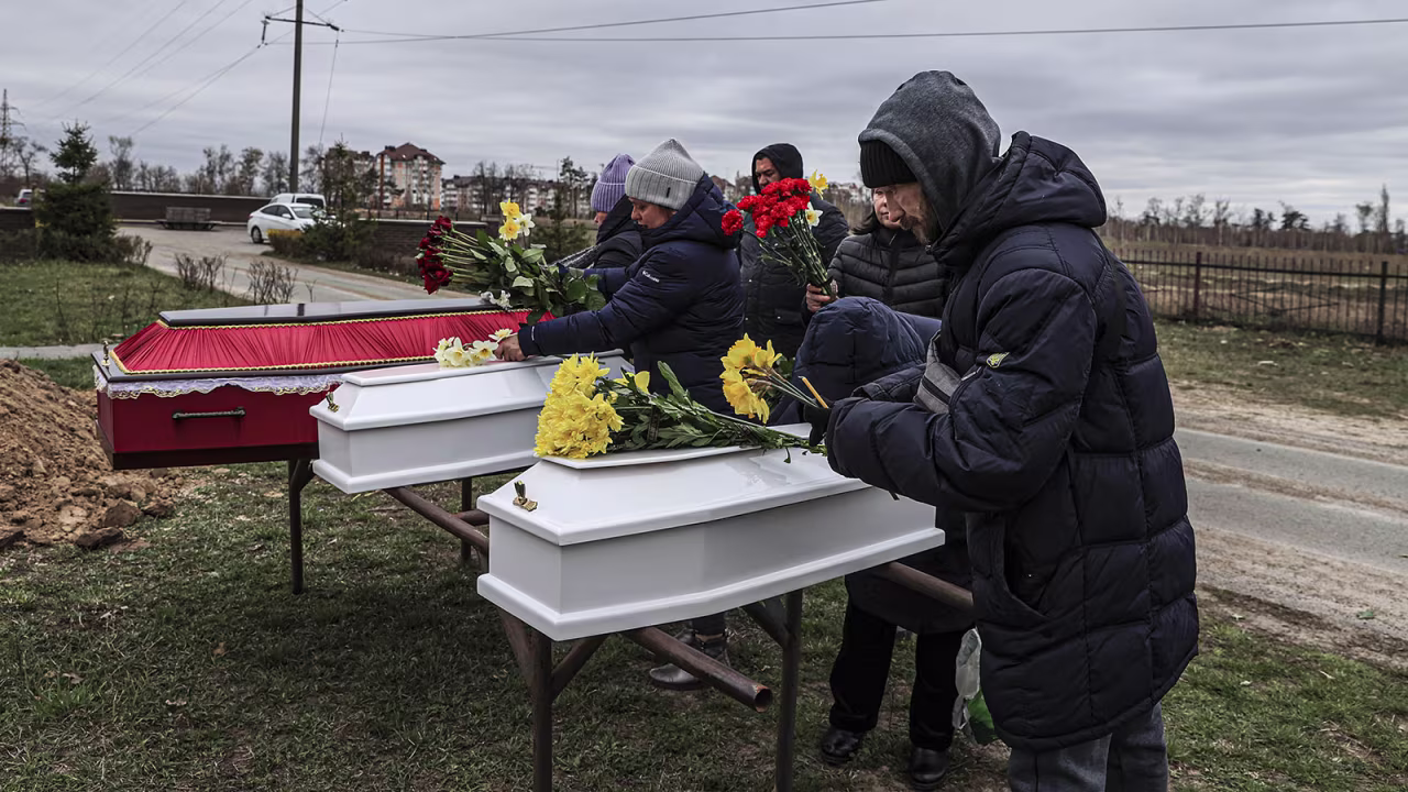 Relatives mourn at a funeral for two children and a mother in Bucha, Ukraine, on April 19. 