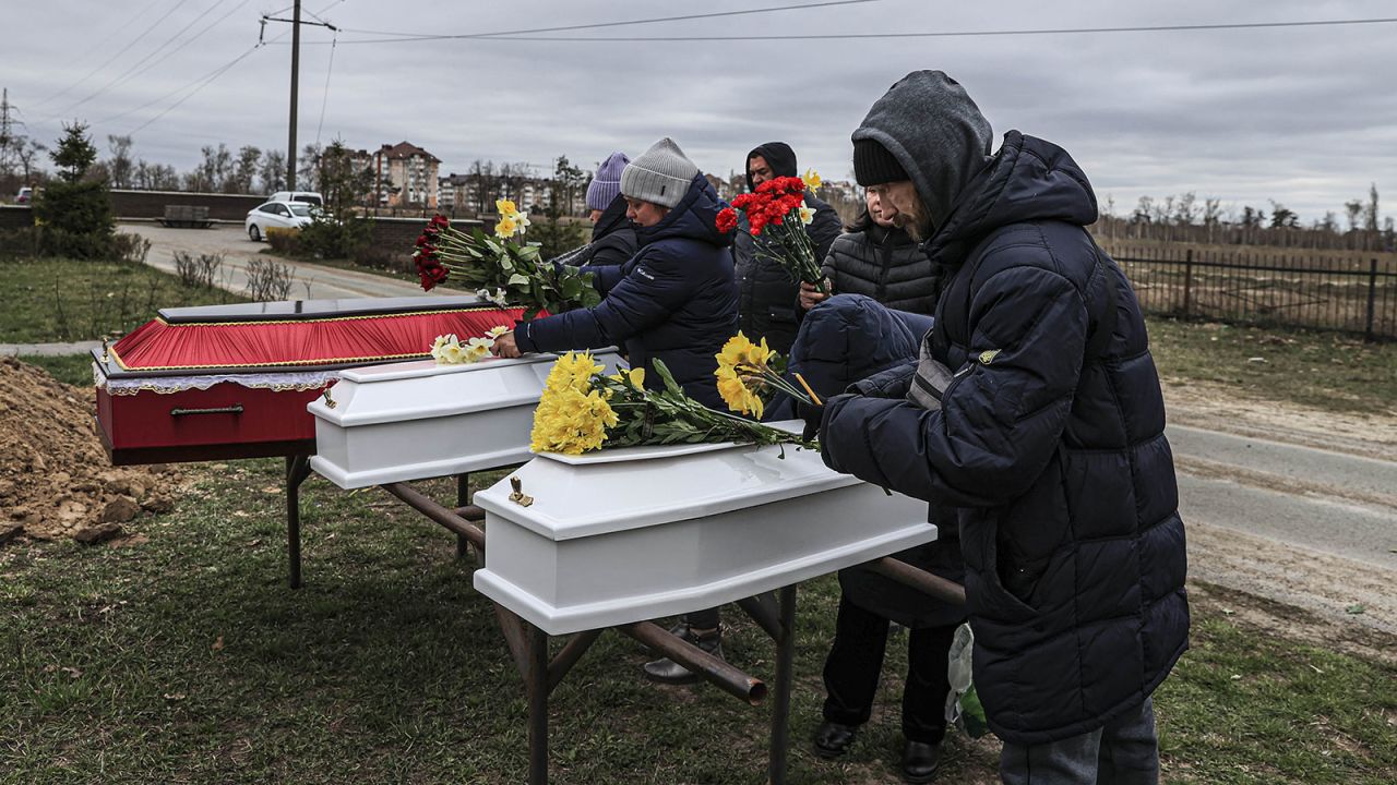 Relatives mourn at a funeral for two children and a mother in Bucha, Ukraine, on April 19. 