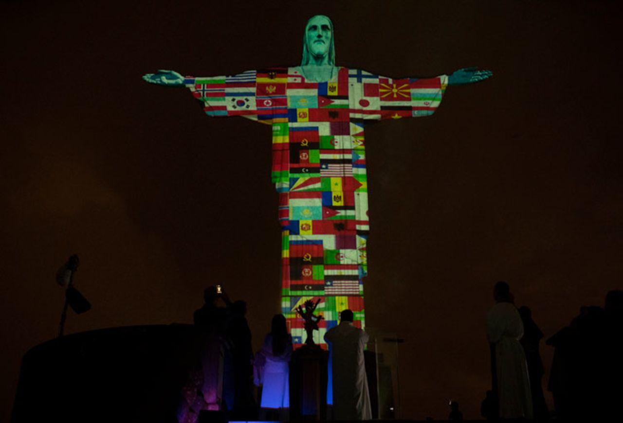 Rio's Christ the Redeemer statue is lit up with the flags of countries currently afflicted by the coronavirus in Rio de Janeiro, Brazil, Wednesday, March 18. 