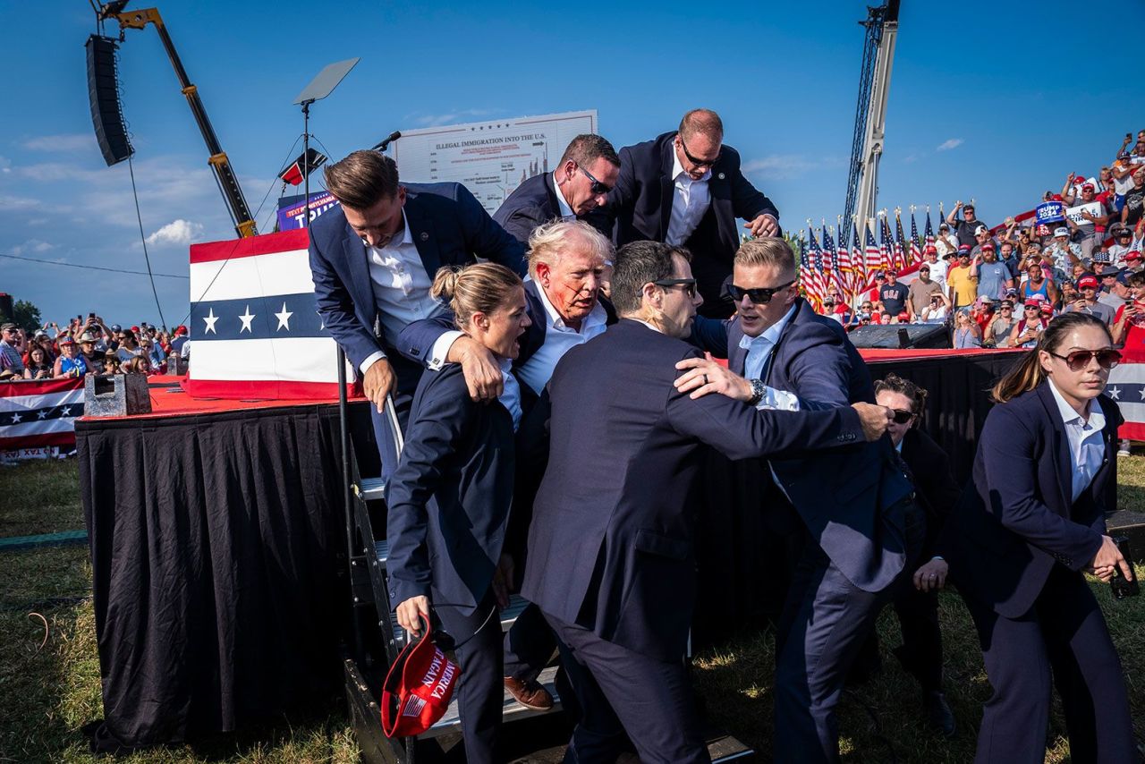 Secret Service agents remove former president Donald Trump from the stage with blood on his face during a campaign rally in Butler, Philadelphia, on July 13.