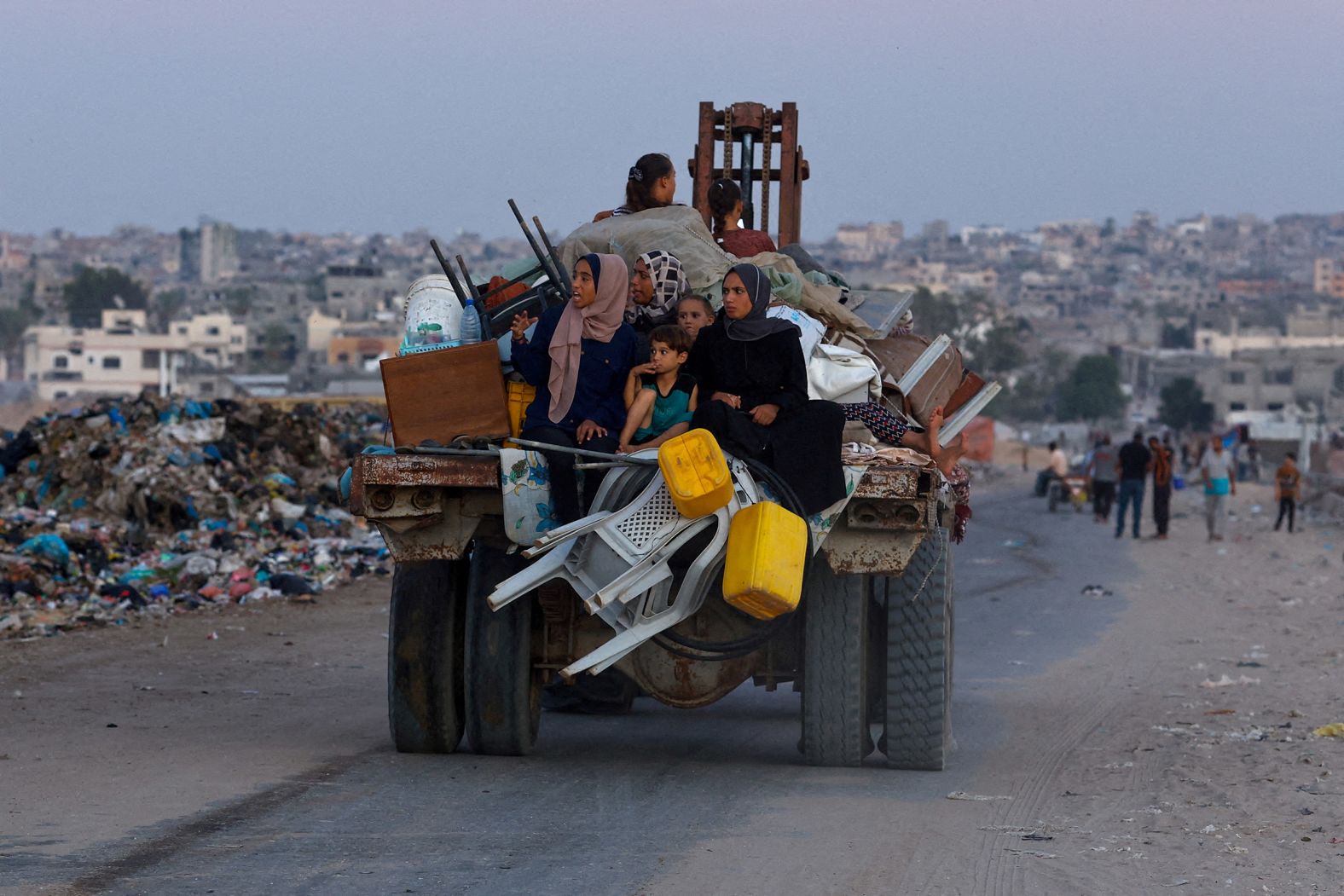 Displaced Palestinians travel on a cart after fleeing the western part of Khan Younis, Gaza, following an evacuation order by the Israeli army on August 21.