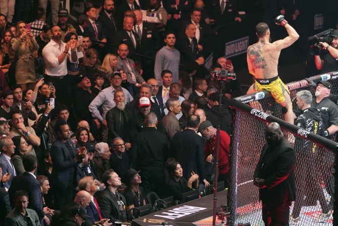 Musk, seen cageside at the lower left, sits next to Trump during a UFC event in New York in November 2024.