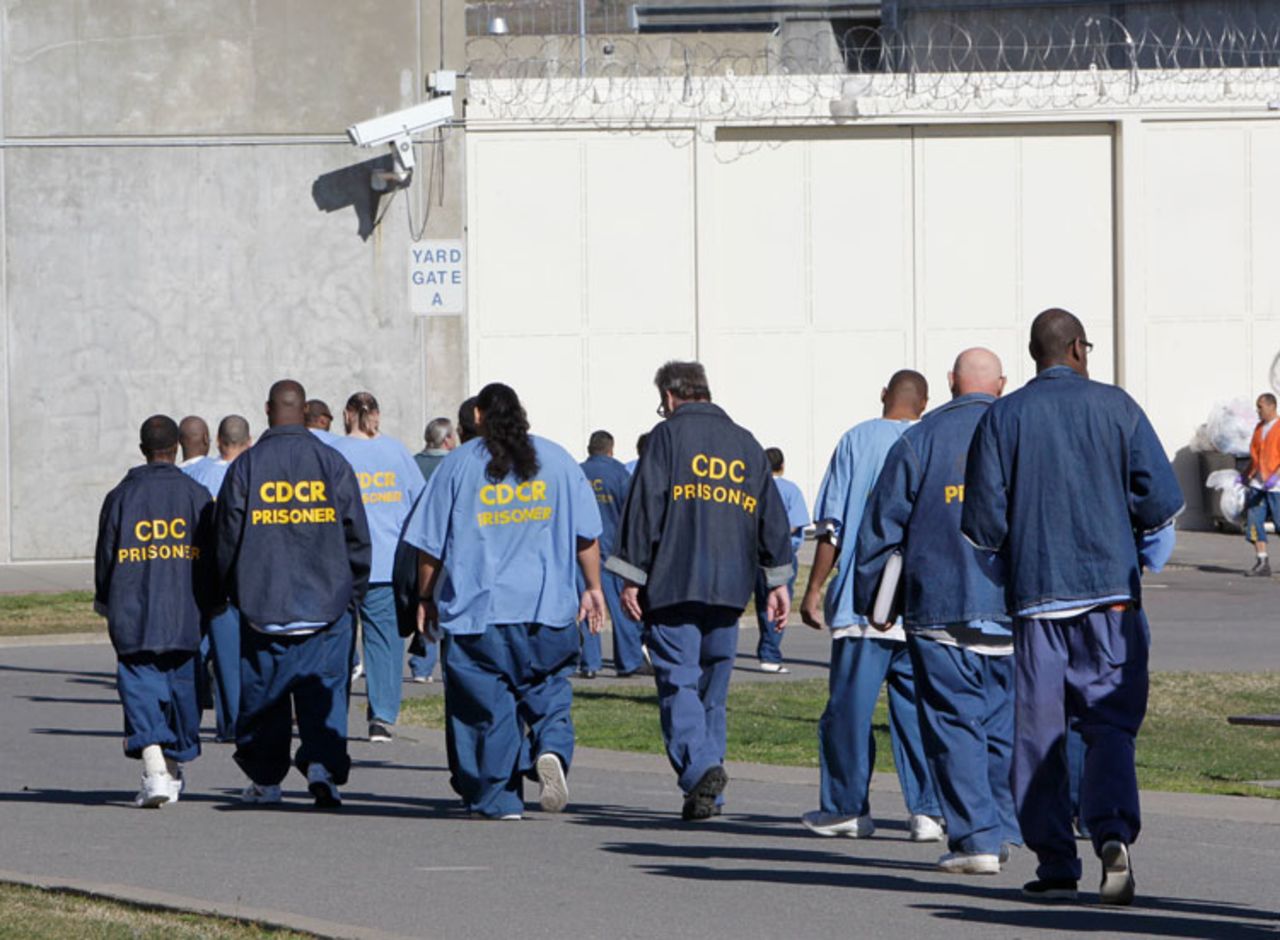 In this February 26, 2013 file photo, inmates walk through the exercise yard at California State Prison Sacramento, near Folsom, California.