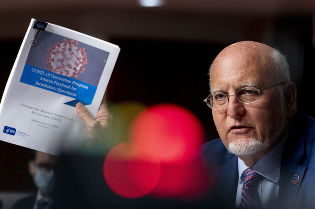 Dr. Robert Redfield holds up a CDC document while he speaks at a hearing of the Senate Appropriations subcommittee reviewing coronavirus response efforts on September 16 in Washington.