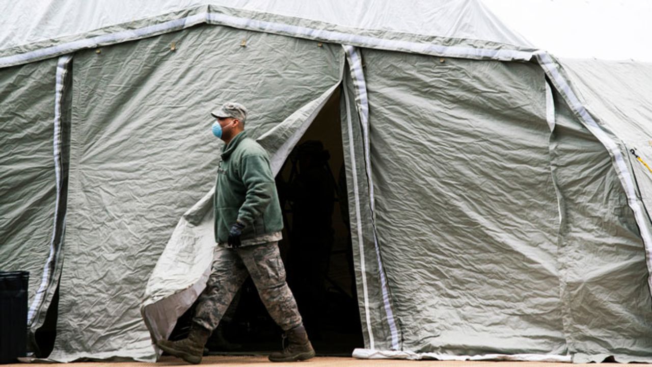 An Air Force member exits a tent builded as makeshift morgue outside of Bellevue Hospital on March 25 in New York City.