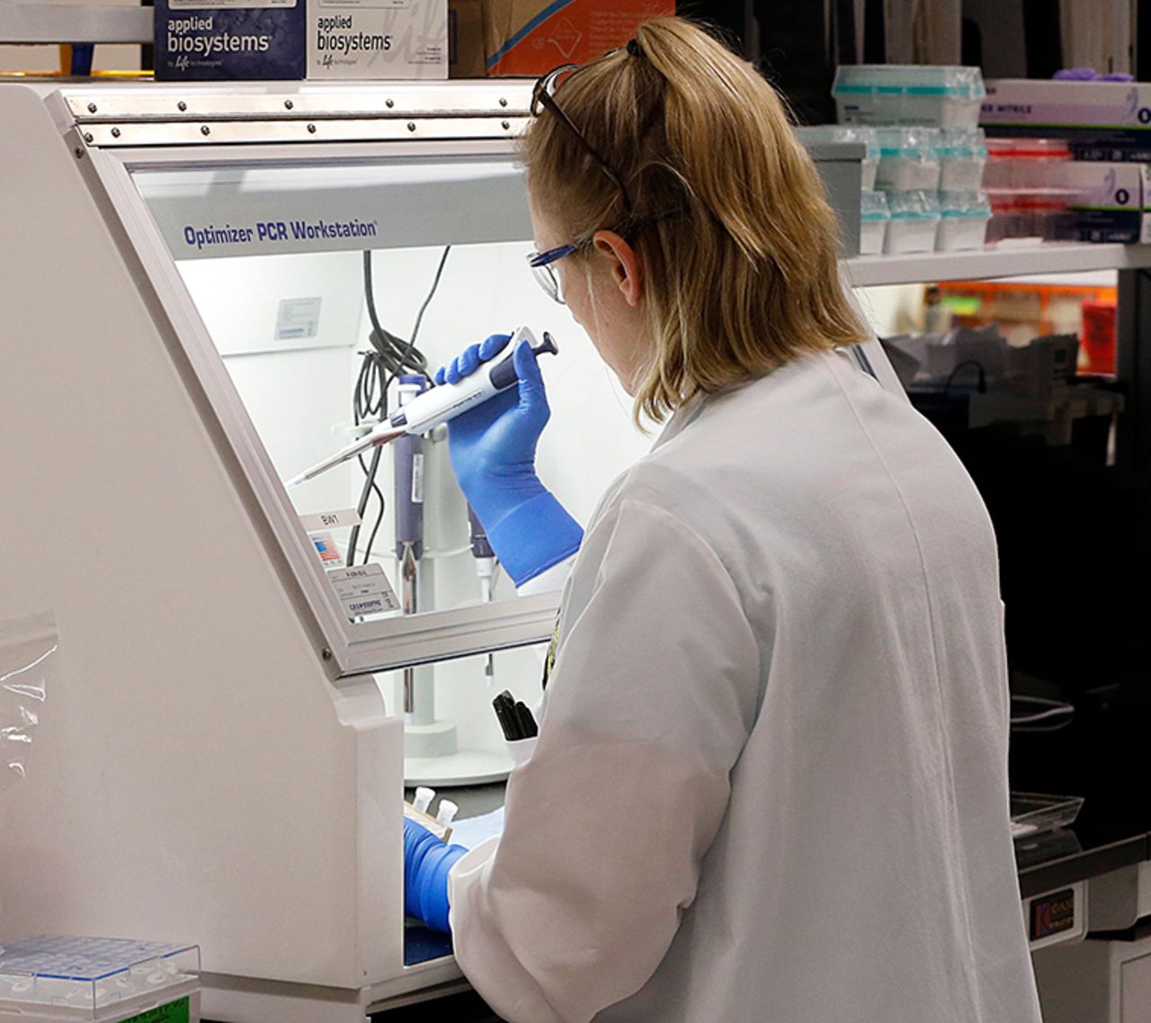 An employee of the Department of General Services Division of Consolidated Laboratories' Virginia Public Health Labratory adds chemicals in the second step of testing a sample for the Coronavirus at the lab in Richmond, Virginia. on Wednesday, March 4. 