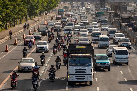 Cyclists ride along a bike lane alongside traffic in Quezon city, Metro Manila, Philippines, on April 27.