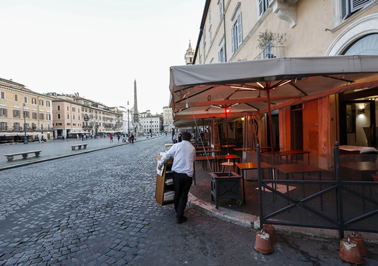 A waiter closes a pizza shop in Rome, on Wednesday, March 11. 