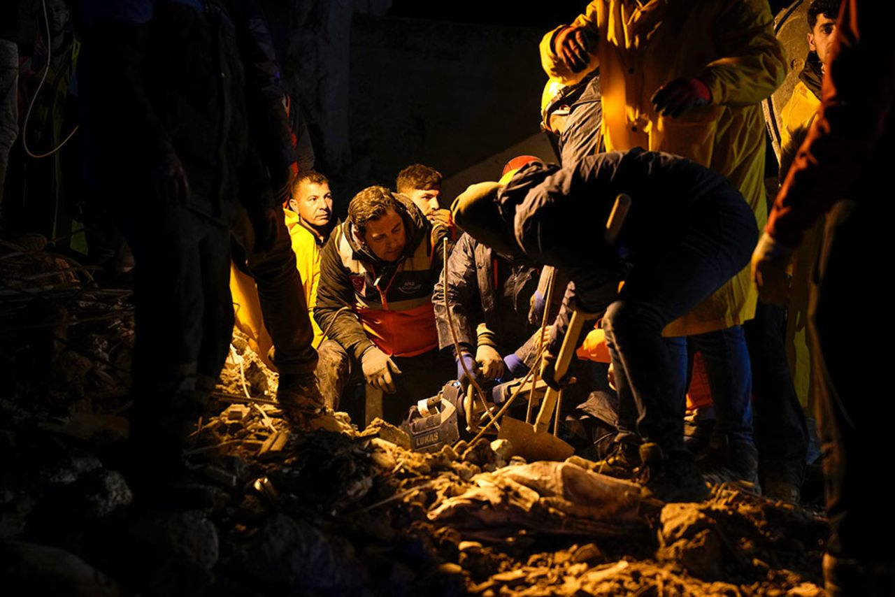 Emergency teams search rubble for victims in a destroyed building in Adana, Turkey.