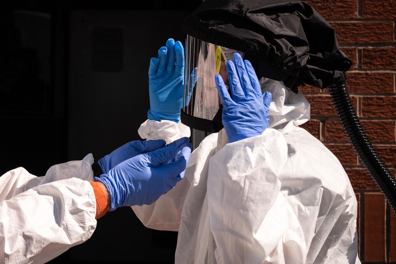 Paramedics check their personal protective equipment during a training exercise while on emergency standby at the Warwickshire & Northamptonshire Air Ambulance base in Coventry, England, on April 20.