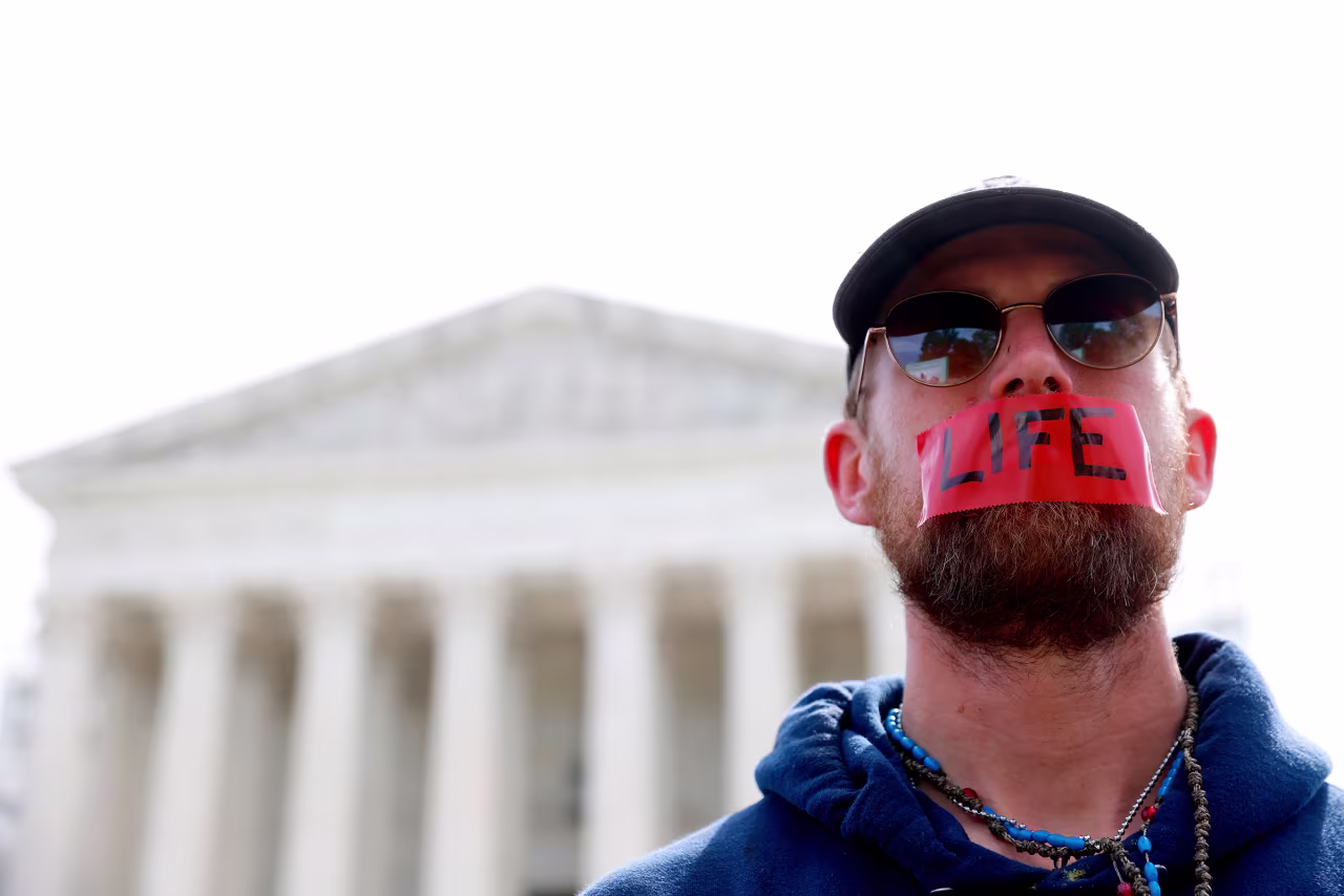 A demonstrator with the word "LIFE" written on tape covering his mouth stands outside the US Supreme Court on Wednesday.