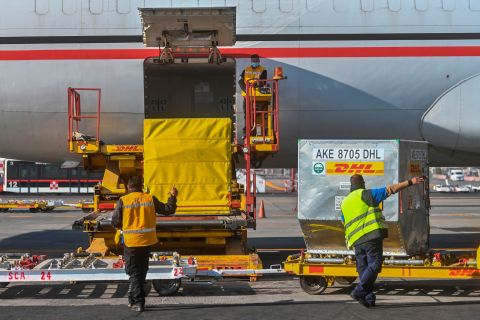 Workers unload containers carrying a shipment of the Pfizer/BioNTech COVID-19 vaccine at Benito Juarez International Airport in Mexico City on December 26, 2020. 