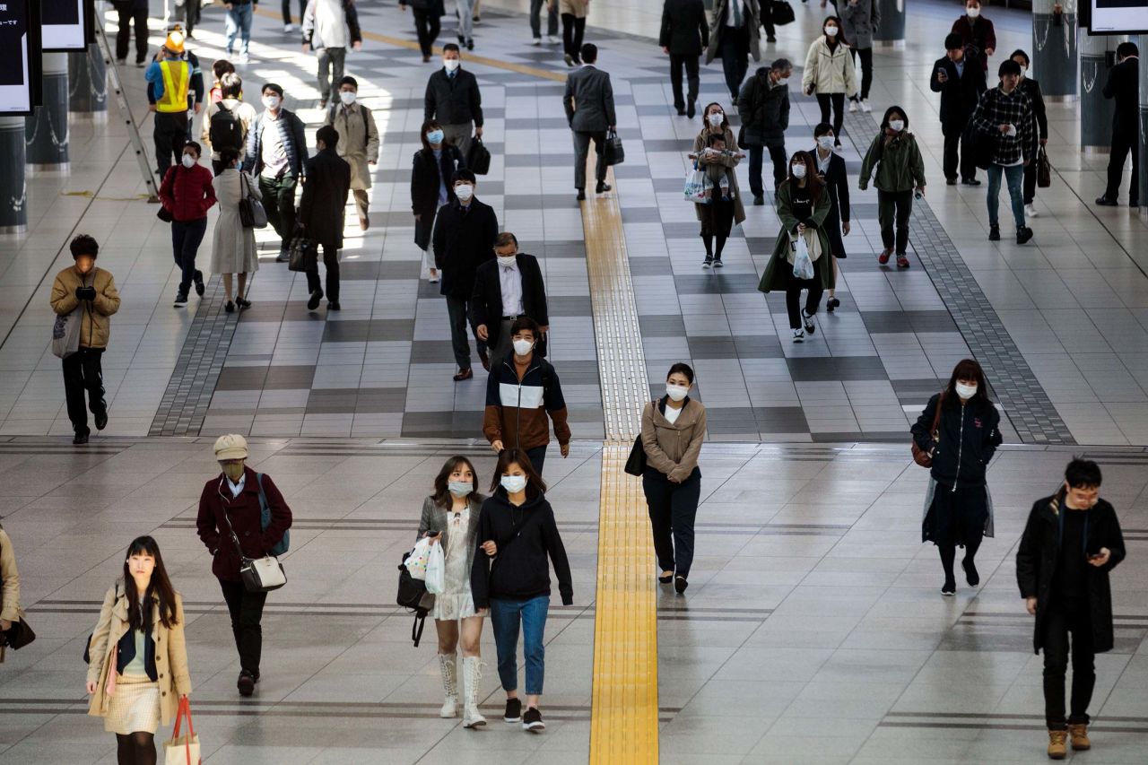 Commuters wearing face masks pass through Shinagawa station in Tokyo, Japan, on April 6.