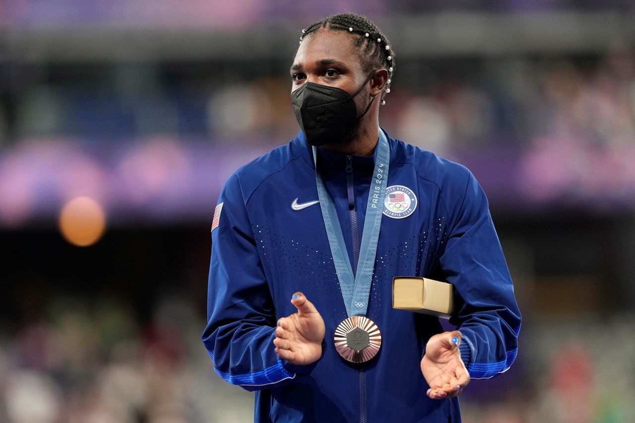 American sprinter Noah Lyles applauds while receiving his bronze medal from Thursday's 200-meter race during the medal ceremony Friday. 