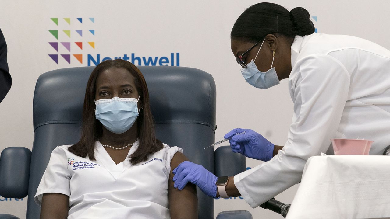 Sandra Lindsay, left, a nurse at Long Island Jewish Medical Center, is inoculated with the Pfizer-BioNTech Covid-19 vaccine by Dr. Michelle Chester on Monday, Dec. 14, in New York. 