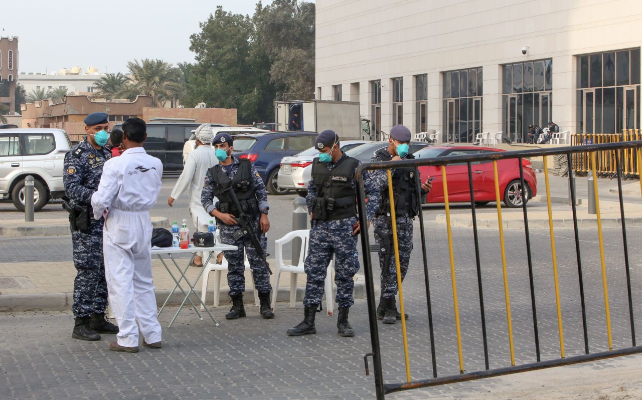 Members of Kuwait's national guard keep watch outside a hotel in the capital where Kuwaitis returning from Iran are quarantined and tested for coronavirus.