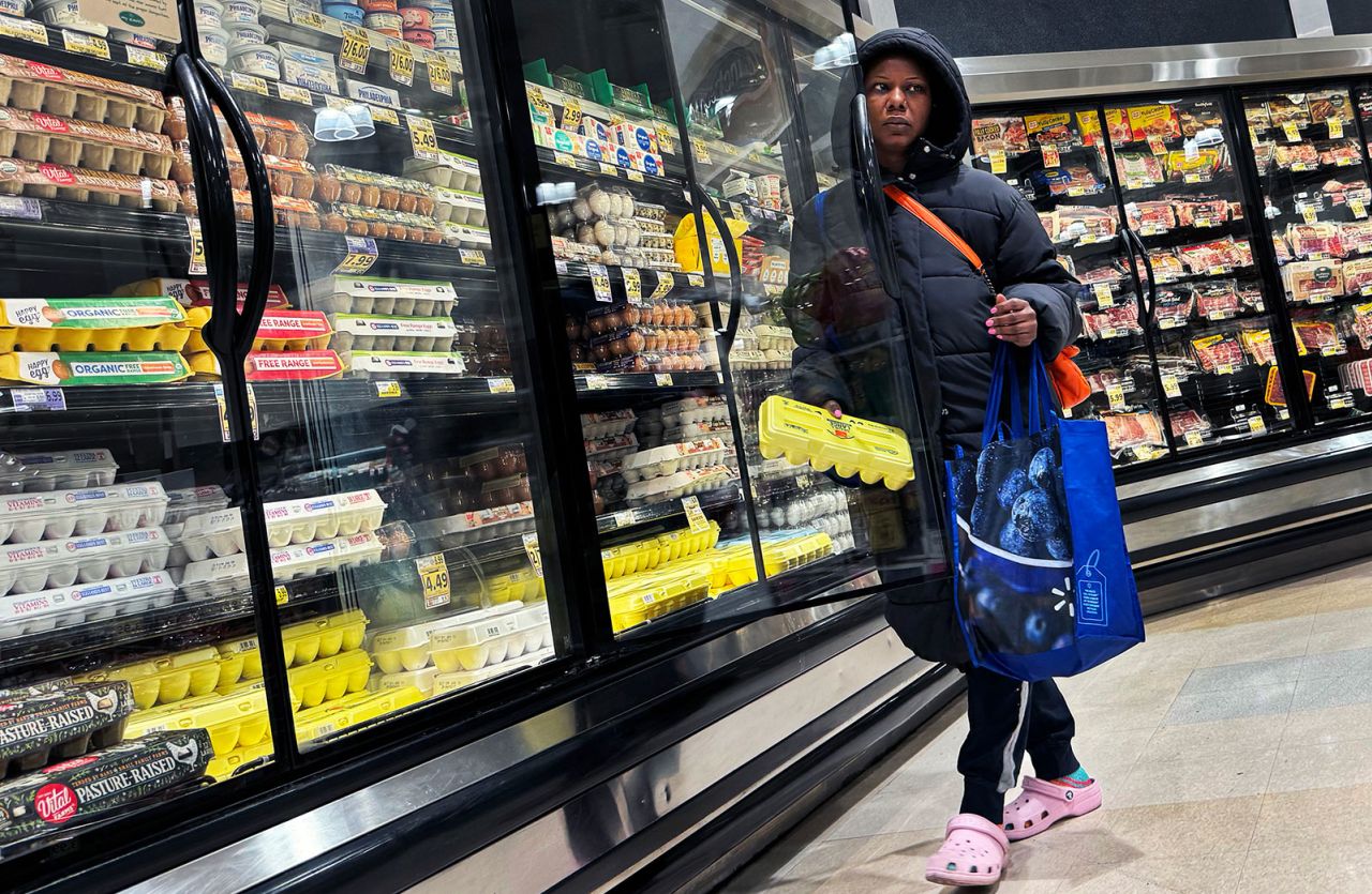 A shopper takes a carton of eggs from the cooler in a grocery store in Washington, D.C., on Saturday, April 6.