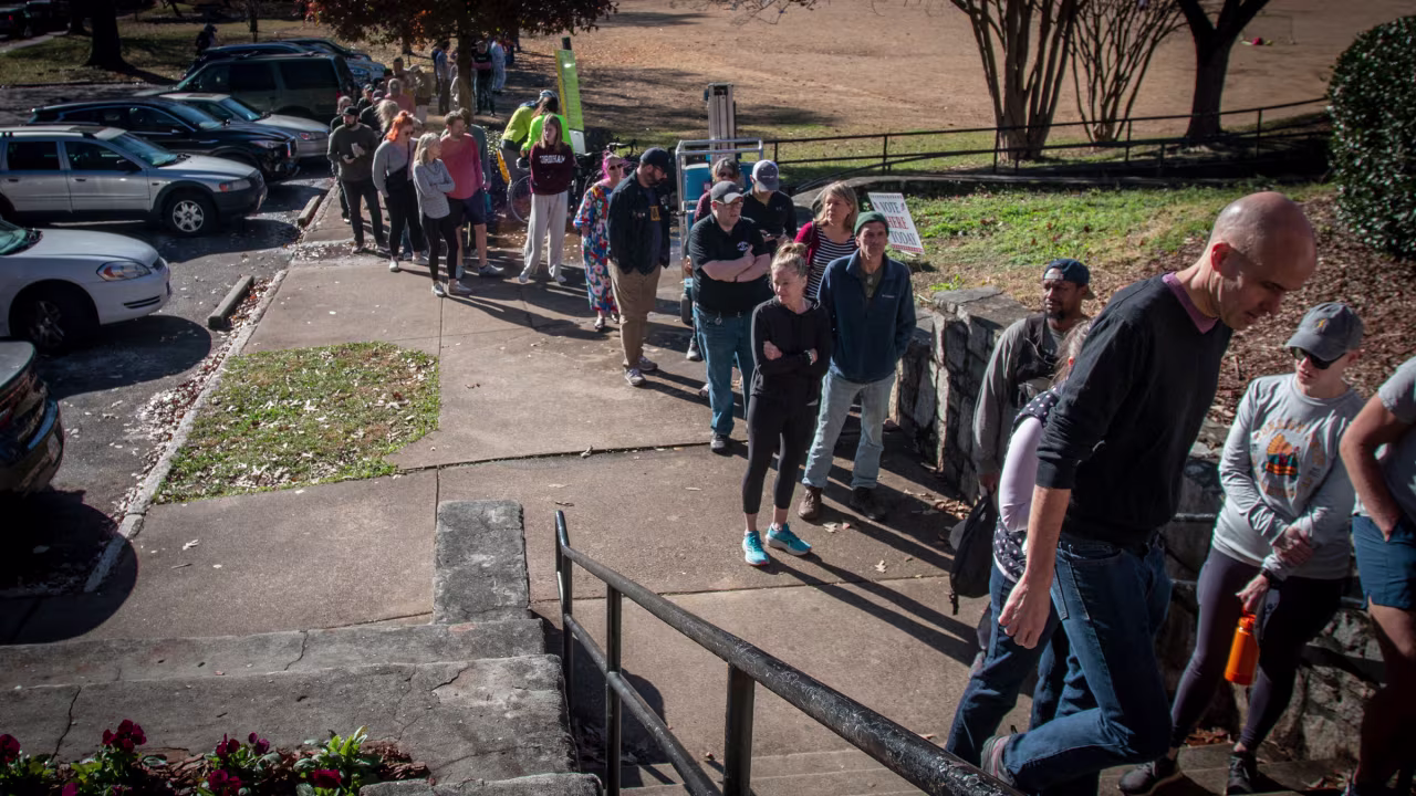 Voters wait in line to cast their ballots in Atlanta on November 27.