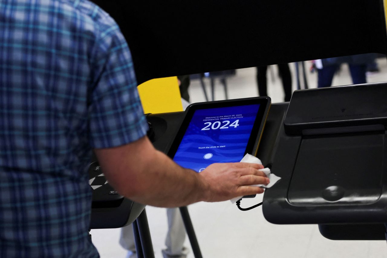 A poll volunteer cleans a voting booth in Burbank, California.