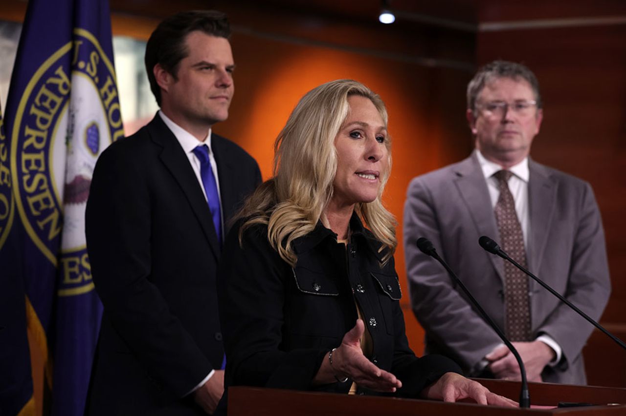 Rep. Marjorie Taylor Greene  speaks as Rep. Matt Gaetz, left, and Rep. Thomas Massie listen during a news conference at the US Capitol on Thursday, November 17.