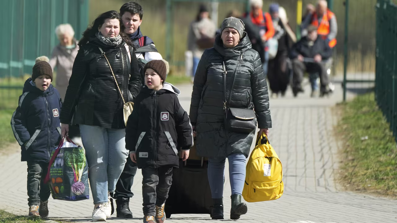 Ukrainian refugees cross the border at Medyka, Poland on Friday April 8.