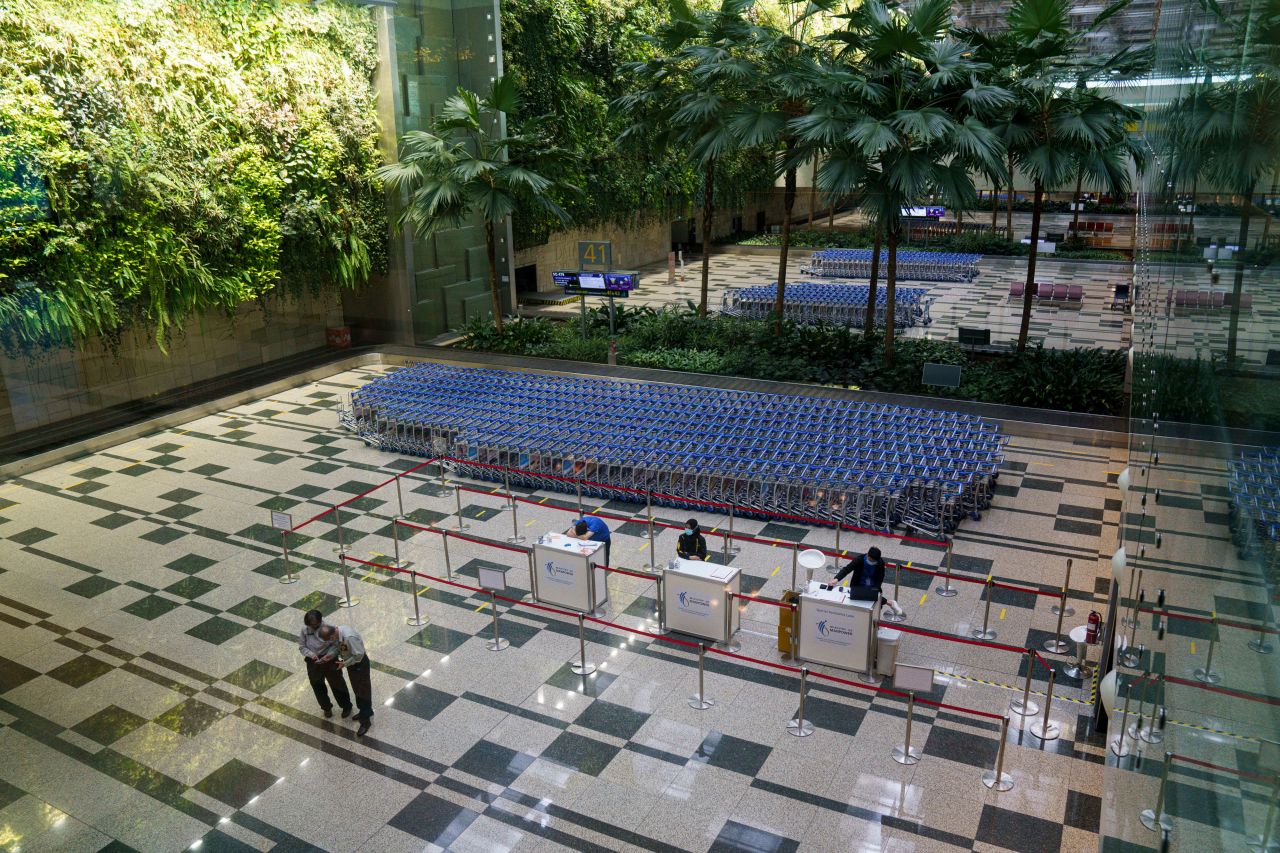 Staff at Changi Airport in Singapore are stationed at an arrival hall on November 11.