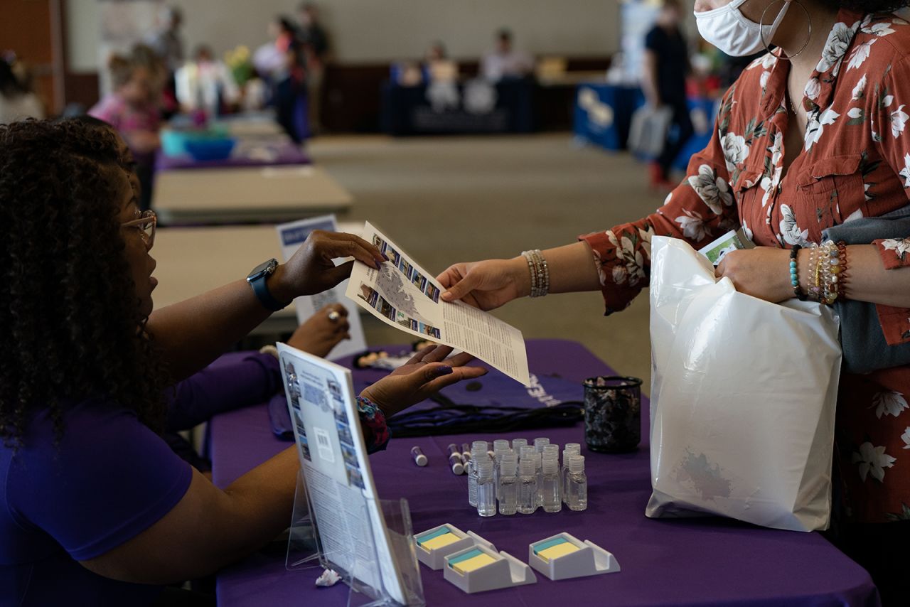 A representative hands a flyer to an attendee at a healthcare career fair at Cape Fear Community College in Wilmington, North Carolina, on Feb. 28.