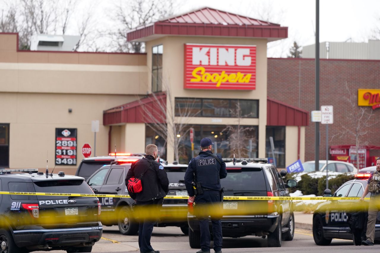 Police stand outside a King Soopers grocery store where a shooting took place on March 22 in Boulder, Colorado.